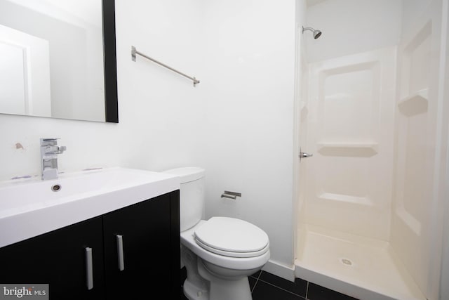 bathroom featuring walk in shower, toilet, tile floors, and vanity