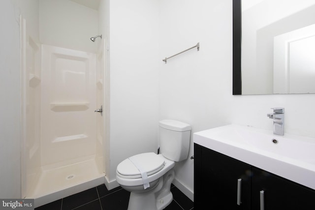 bathroom featuring tile flooring, walk in shower, vanity, and toilet