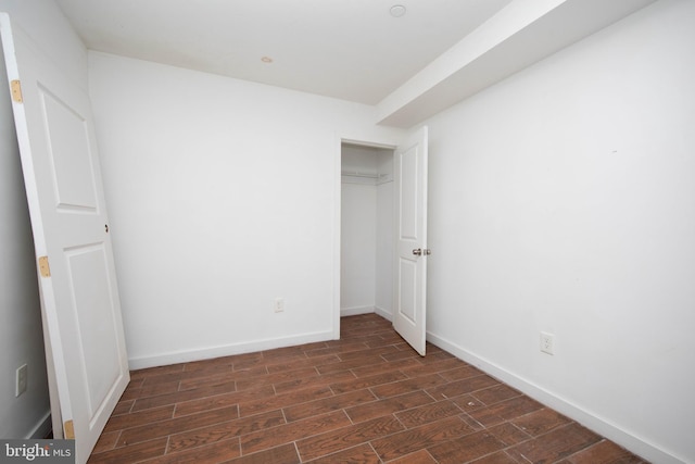 unfurnished bedroom featuring dark hardwood / wood-style flooring