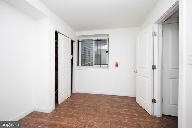 unfurnished room with dark hardwood / wood-style flooring