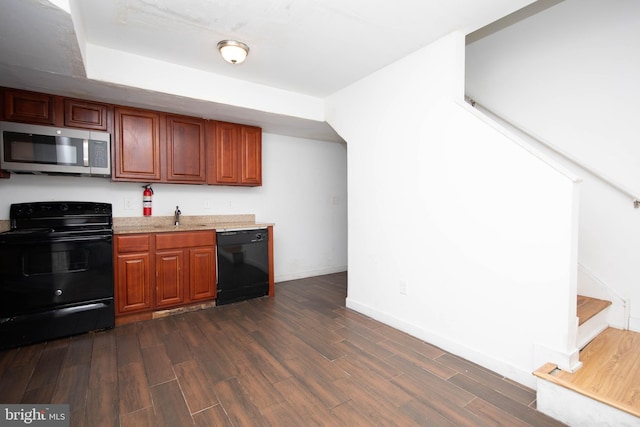 kitchen with dark hardwood / wood-style flooring, sink, and black appliances