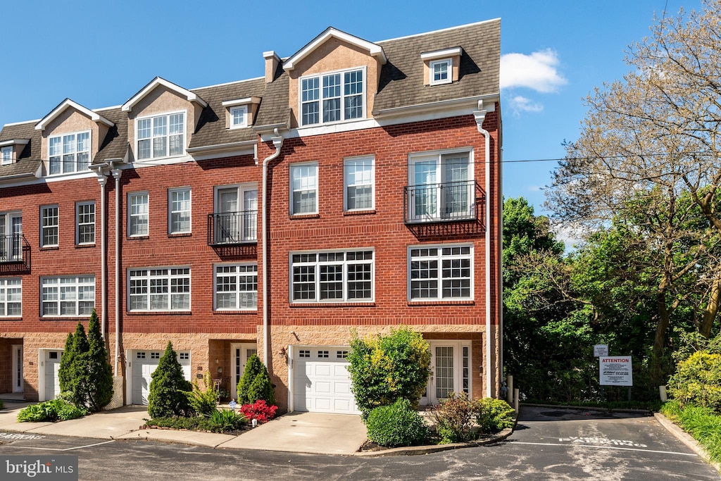 townhome / multi-family property featuring a garage and a balcony