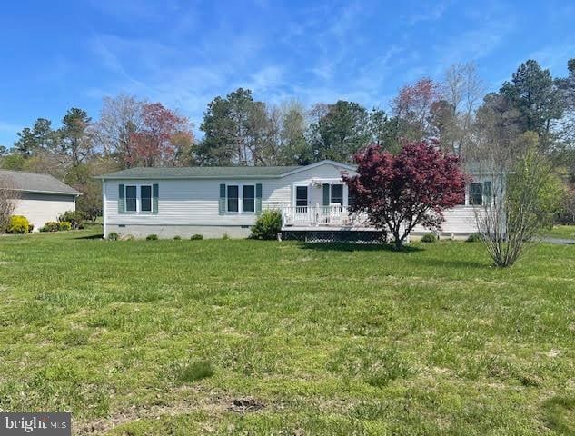 view of front of home with a front lawn and a deck