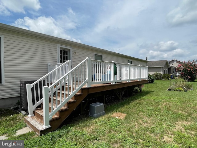 back of property featuring a yard and a wooden deck