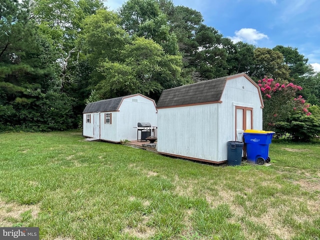 view of outbuilding featuring a lawn