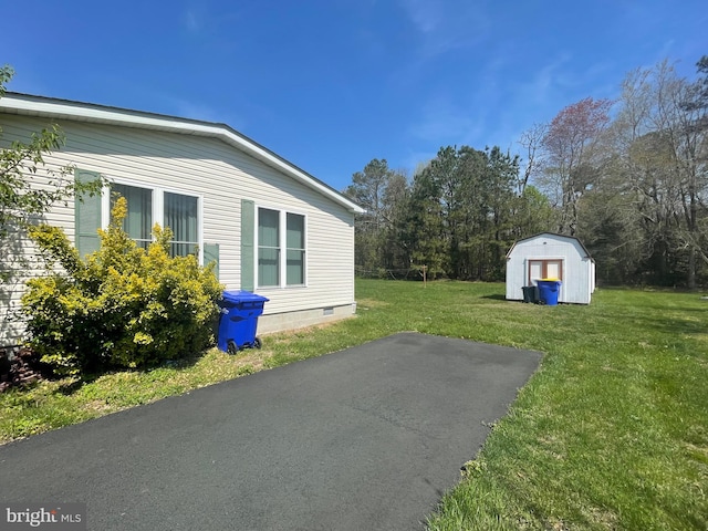 exterior space with a lawn and a storage unit