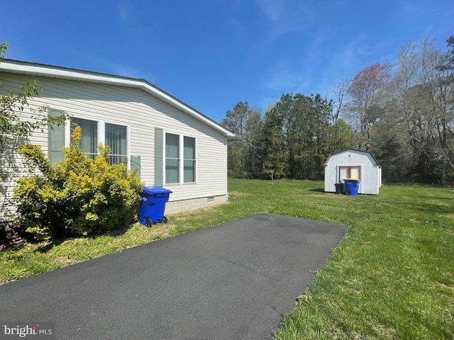 exterior space with a yard and a shed