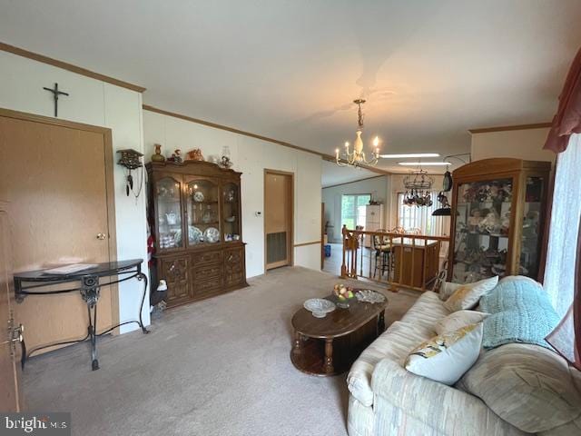 living room with an inviting chandelier, ornamental molding, and carpet flooring