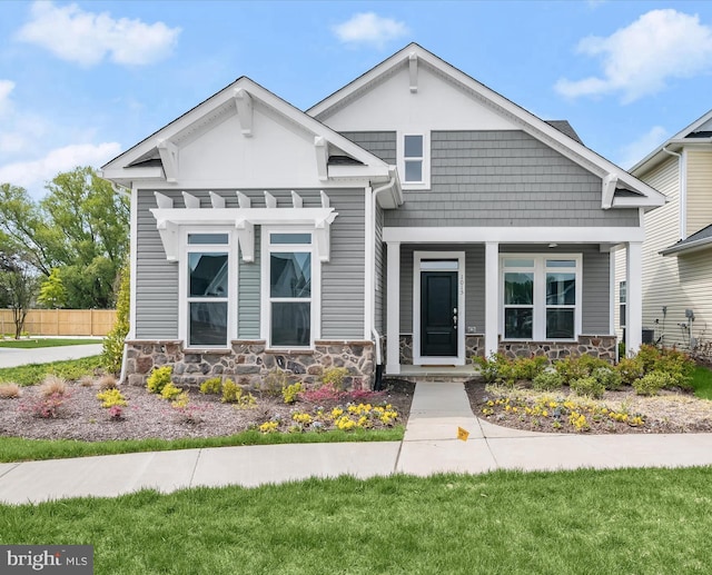 view of front of house with a pergola and a front lawn