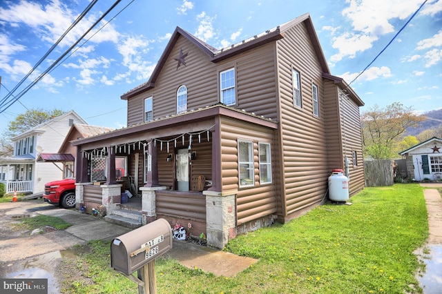 view of front of house featuring a porch and a front yard