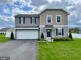 view of front facade with a front yard and a garage