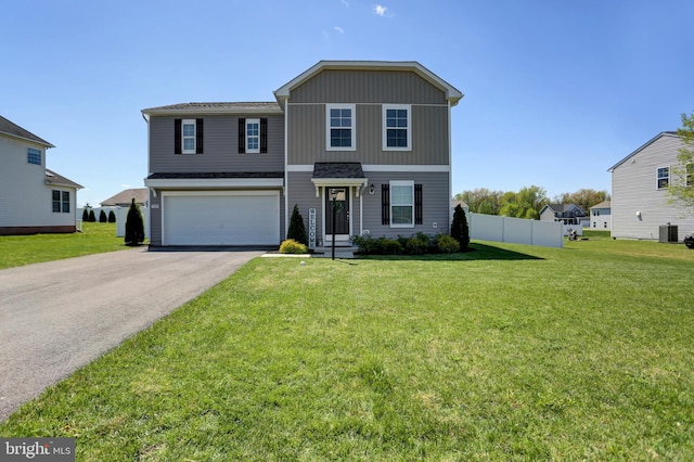 view of front property featuring a front yard and a garage