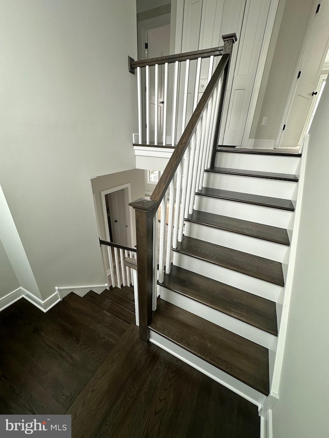 stairs with hardwood / wood-style flooring