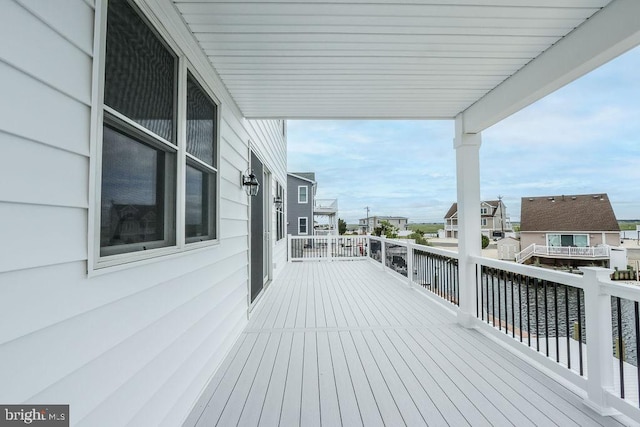 wooden terrace featuring a water view