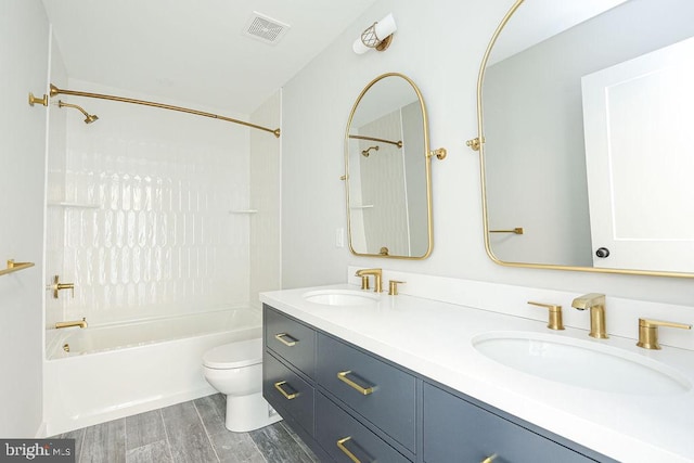 full bathroom featuring hardwood / wood-style flooring, vanity, toilet, and shower / bathing tub combination