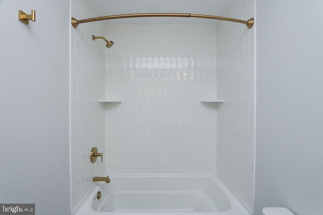 bathroom with toilet and bathing tub / shower combination