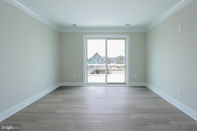 unfurnished room featuring light hardwood / wood-style floors and crown molding