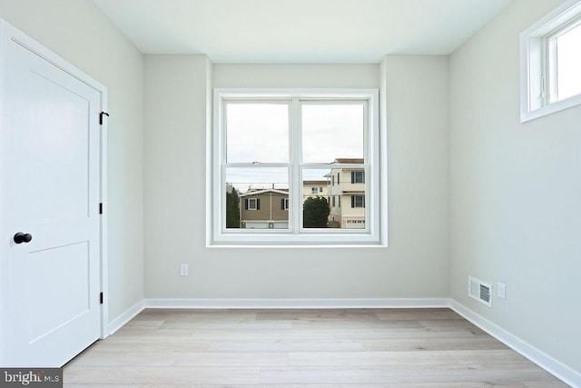 empty room with light hardwood / wood-style flooring