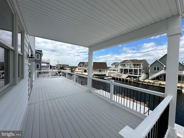 wooden terrace featuring a water view