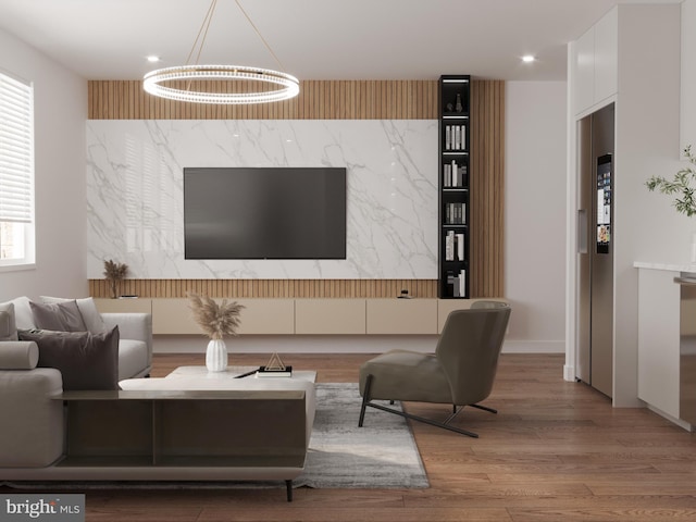 living room with hardwood / wood-style floors and a notable chandelier