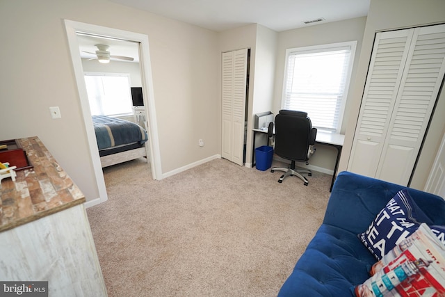 office with light colored carpet and ceiling fan