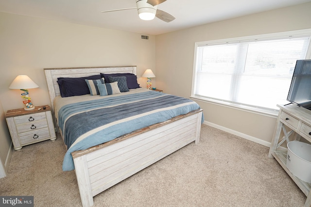 bedroom featuring light colored carpet and ceiling fan