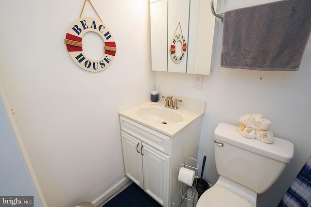 bathroom featuring toilet and vanity