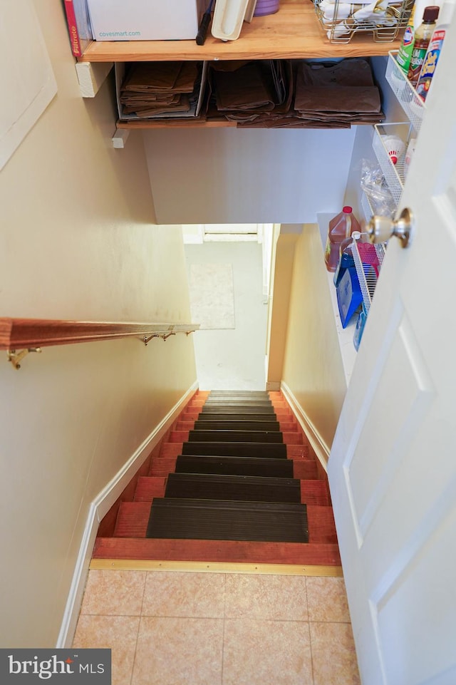 stairs featuring light tile floors