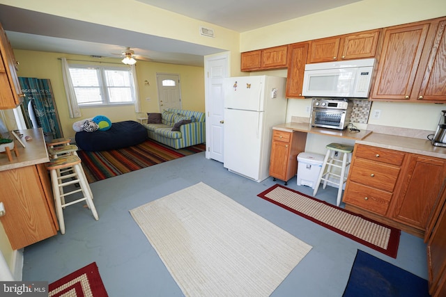 kitchen featuring tasteful backsplash, ceiling fan, and white appliances