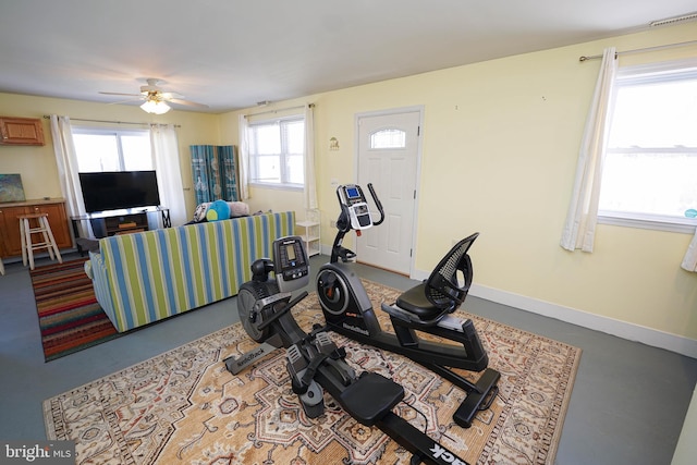 exercise room with ceiling fan