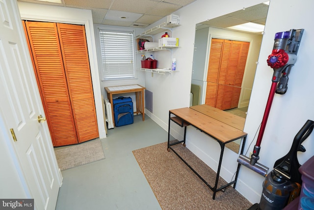 interior space with a paneled ceiling