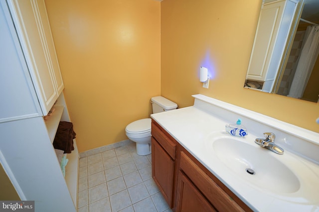 bathroom with oversized vanity, toilet, and tile flooring