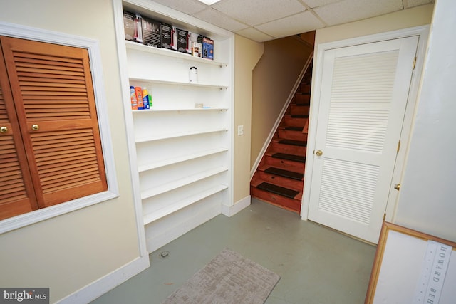 interior space with a paneled ceiling