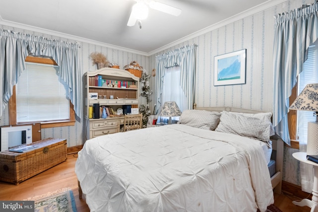 bedroom with wood-type flooring, multiple windows, crown molding, and ceiling fan