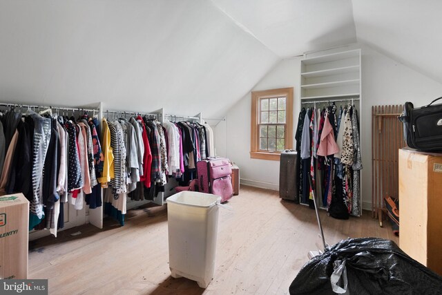 walk in closet featuring lofted ceiling and light hardwood / wood-style flooring