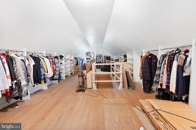 walk in closet featuring wood-type flooring and lofted ceiling