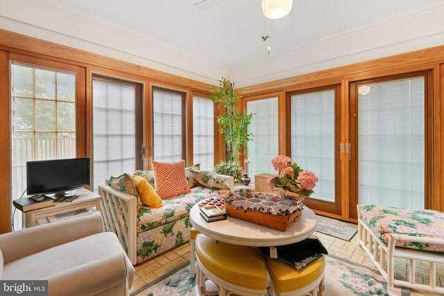 sunroom featuring ceiling fan