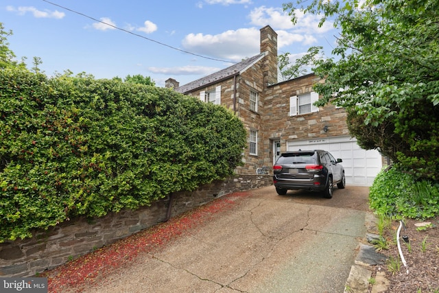 view of side of home featuring a garage