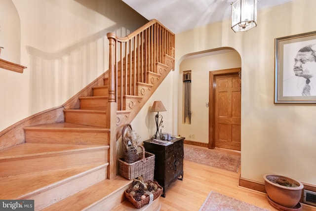 stairs featuring wood-type flooring