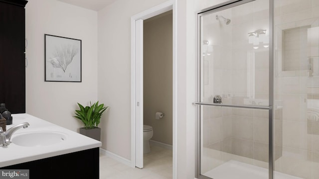 bathroom with an enclosed shower, vanity, toilet, and tile patterned floors