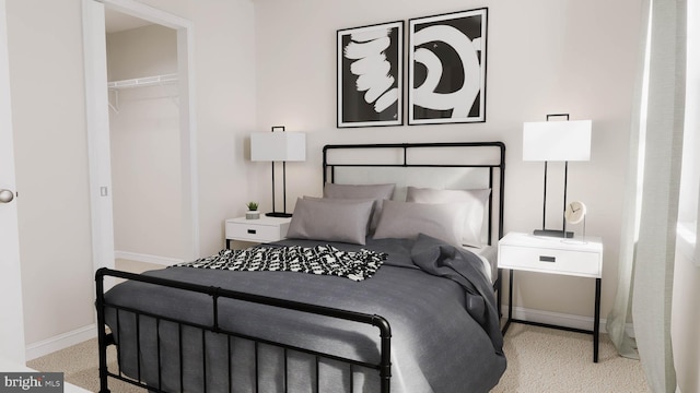 carpeted bedroom featuring a walk in closet and a closet