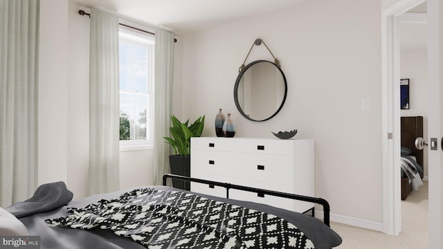 bedroom featuring light carpet and multiple windows