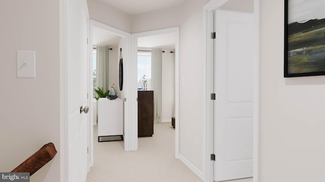 hallway with light colored carpet