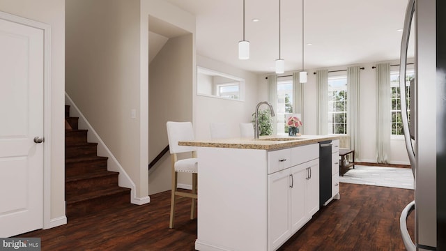 kitchen with a center island with sink, sink, stainless steel fridge, decorative light fixtures, and dark hardwood / wood-style flooring