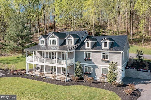 view of front of house with a garage, a balcony, and a front lawn