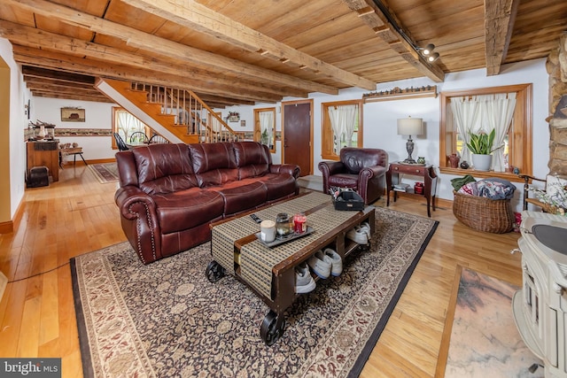 living room featuring wooden ceiling, beam ceiling, and light hardwood / wood-style floors