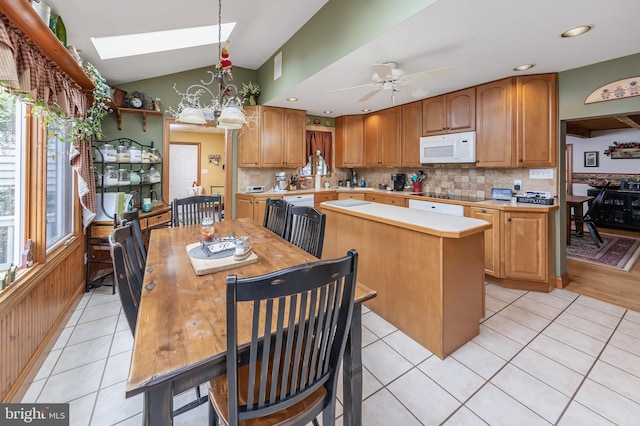 kitchen with a center island, a wealth of natural light, ceiling fan, and light tile floors