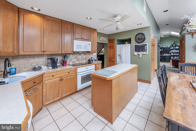 kitchen with a kitchen island, backsplash, white appliances, ceiling fan, and sink