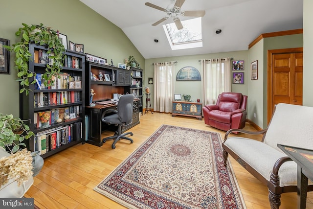 office area featuring lofted ceiling with skylight, ceiling fan, and light wood-type flooring