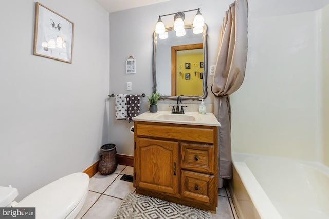 bathroom featuring tile flooring, vanity, and toilet